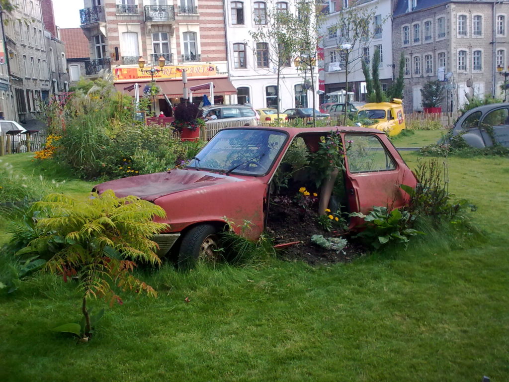 an abandoned car in a park