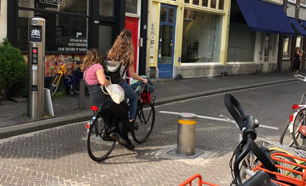 cyclist giving a lift to her friend