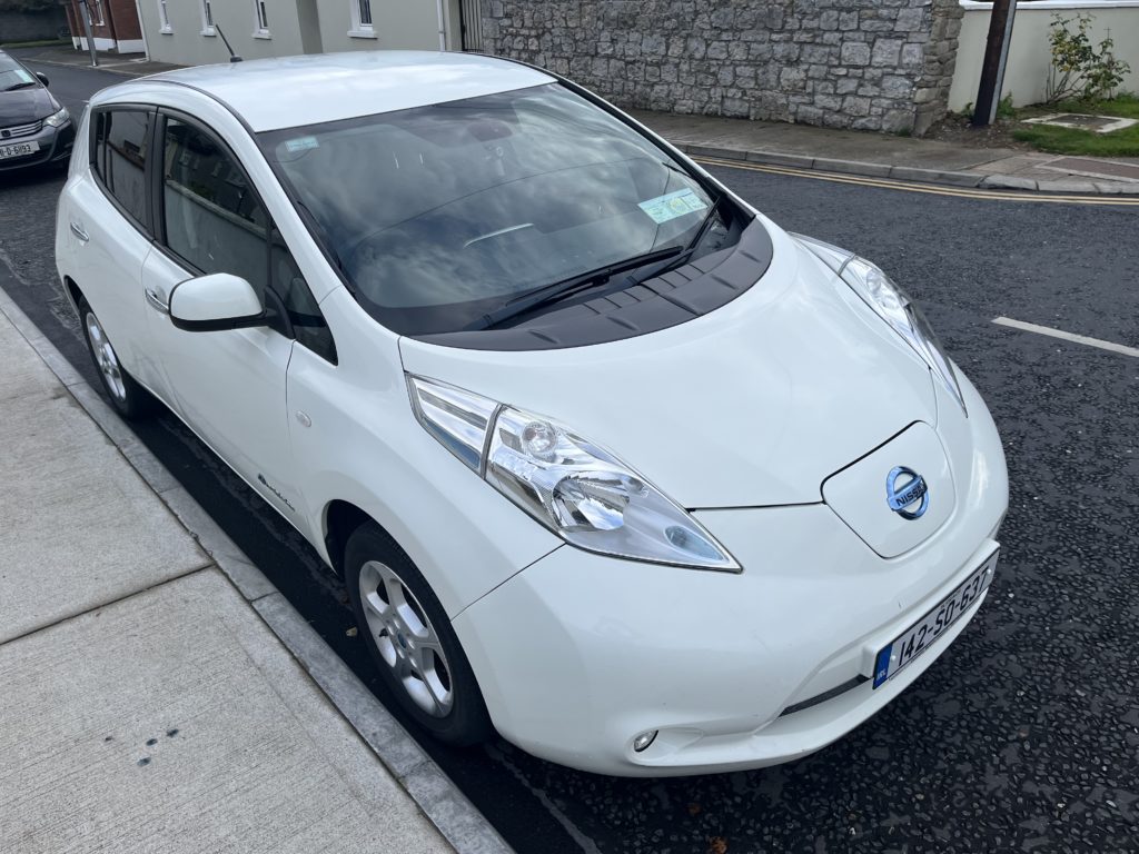 a white Nissan Leaf car